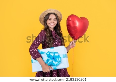 teen girl smile with red heart balloon and present box on yellow background