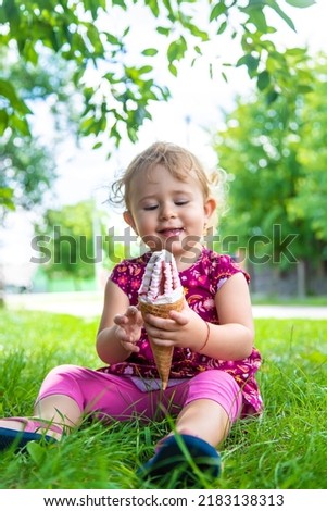 The child eats ice cream on the street. Selective focus. Food.