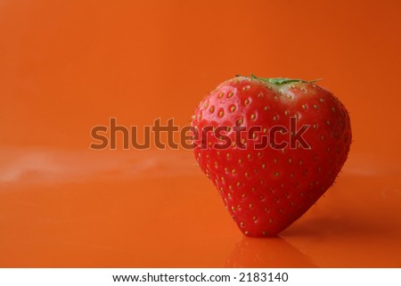 Strawberry on an orange background. Clipping path included. Royalty-Free Stock Photo #2183140