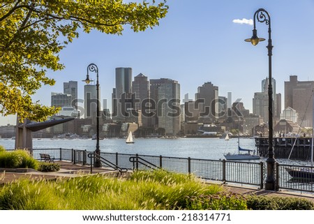 Panoramic view of Boston in Massachusetts, USA showcasing the architecture of its financial distric on the background and the gardens of Piers Park on the foreground.