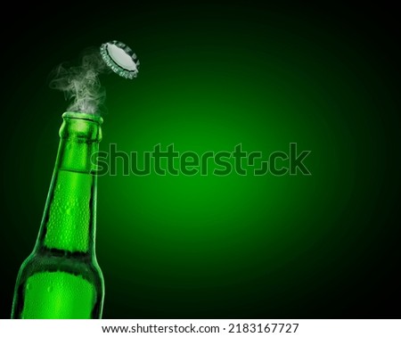 cold wet open beer bottle with smoke on green background Royalty-Free Stock Photo #2183167727