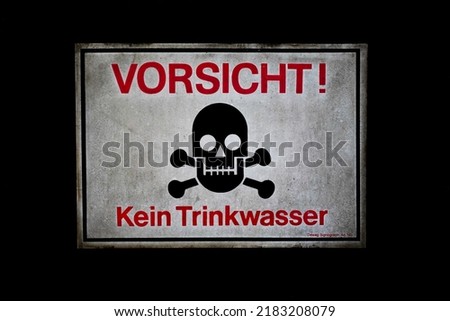 Old shabby warning sign saying "Kein Trinkwasser" which means "not for drinking" in German