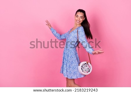 Profile photo of cute brunette young lady turn wear printed dress cross body bag isolated on pink color background Royalty-Free Stock Photo #2183219243