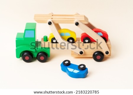 Toy tow truck towing damaged cars after a serious accident. Car traffic, car crash, dangerous incident.