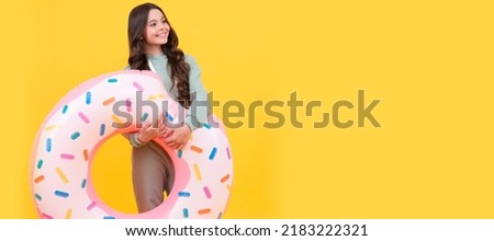 cheerful beach kid in tracksuits with inflatable circle for pool on summer vacation, summer vacation. Horizontal poster of isolated child face, banner header, copy space.