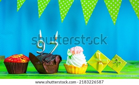 Happy birthday colorful background with decorations with festive garlands with pies and muffins and gift boxes with copy space. Beautiful happy birthday background with number 97 candles