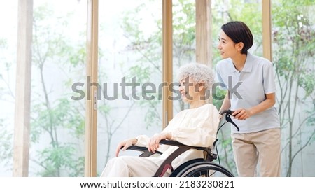 Asian elderly woman and caregiver. nursing care concept. Royalty-Free Stock Photo #2183230821