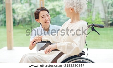 Asian elderly woman and caregiver. nursing care concept. Royalty-Free Stock Photo #2183230869