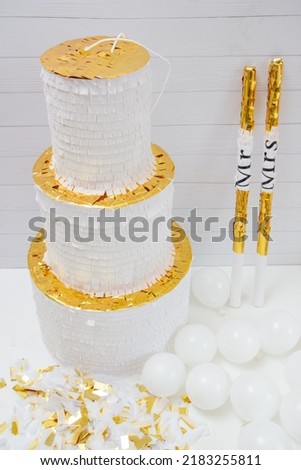White and gold paper wedding cake, white decorative cardboard wedding cake, piñata cake.