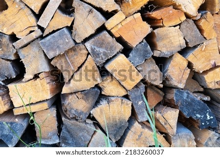Natural wooden logs laid in a log for kindling a stove or fire.
