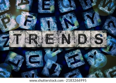 Trends, word on an alphabet on stone blocks, on dark blue background.Business. Background.