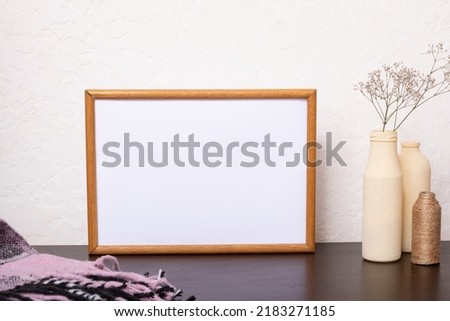 Mock up empty wooden frame mockup, dried grass in vases on white background, interior, home design. Art concept. copy space