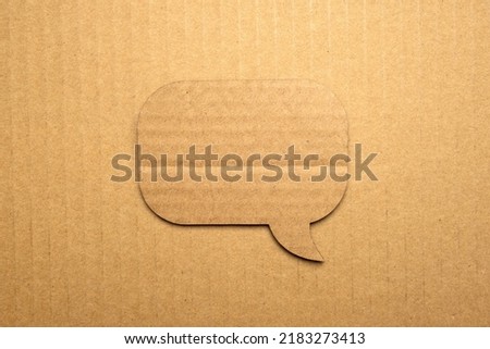 Speech bubble paper on cardboard background Royalty-Free Stock Photo #2183273413
