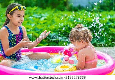 Children swim in the pool. Selective focus. Kid.