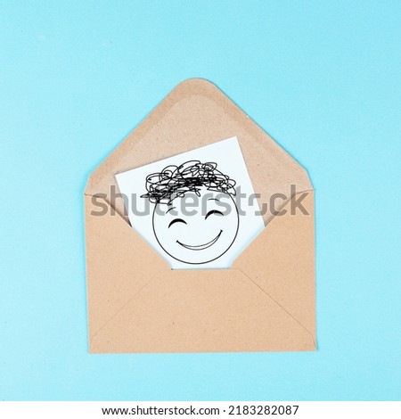 Smiling happy face on a paper inside an evelope, positive emotions, good customer feedback, greeting card 