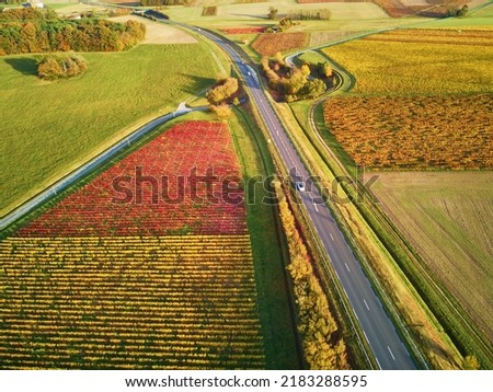 Aerial view of pastures, farmlands and vineyards in France. Beautiful French countryside with green fields and meadows. Rural landscape on sunset Royalty-Free Stock Photo #2183288595