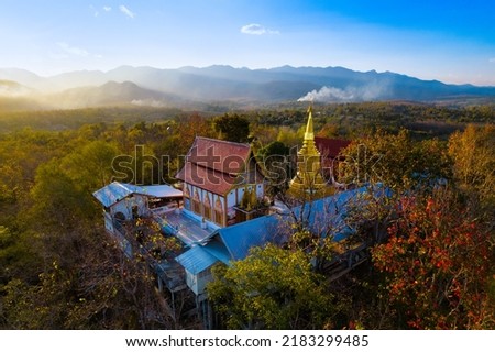 Aerial shot of the Wat Phrathat jom jaeng temple with a beautiful sunset, Pai province, Thailand