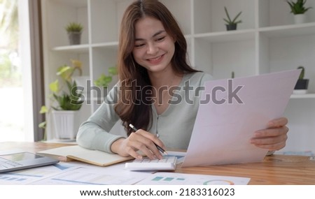 Asian businesswoman working in the office with working documents.
