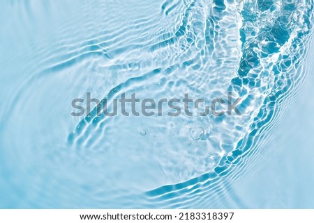 Blue water texture, cosmetic background turquoise water surface with rings and ripples Royalty-Free Stock Photo #2183318397