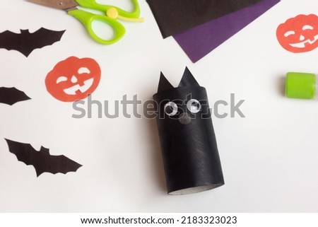 Step by step photo instruction of Halloween craft. Step 6 Handmade decoration cute funny cat from toilet paper roll. Do it yourself. Reuse concept