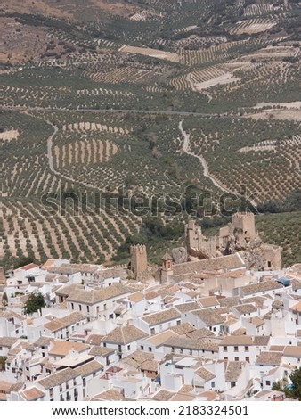 view of the historic center and the castle of the town of Zuheros in Córdoba and in the background a countryside of olive trees Royalty-Free Stock Photo #2183324501