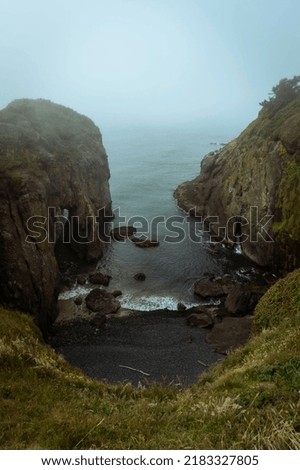 This photo depicts an extreme angle of a small cove on the coast of Oregon. On this day of shooting there was an unusual cast of fog presented that created a nice depth in the photo