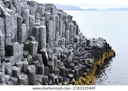 Tall and gray basalt columns - northern coast of Iceland in Europe Royalty-Free Stock Photo #2183329449