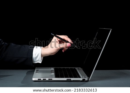 Businesswoman Pointing With Pen Important Message On Lap Top Screen. Woman Showing Crutial Information On Computer. Lady In Suit Presenting Recent Announcements.