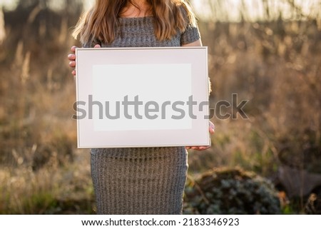 White picture frame with decorations. Mock up for your photo or text. Place your work, print art, white background, pastel color book. Photo realistic 3d illustration. Girl holding frame