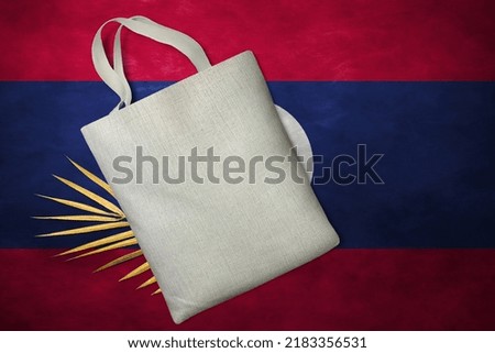 Patriotic tote bag mock up on background in colors of national flag. Laos