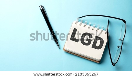 LGD - Loss Given Default text written on notepad on the blue background Royalty-Free Stock Photo #2183363267