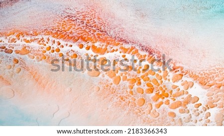 Artistic texture painted with liquid acrylic paints. Fluid art for background, wallpapper or poster. Backdrop similar to the landscape of the ocean. Sea artwork with sandy coast and white foam.