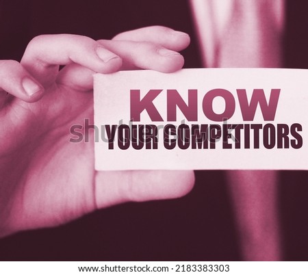 Businessman putting a card with text know your competitors. Business concept.