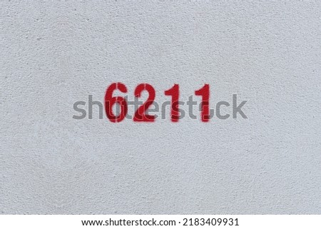 Red Number 6211 on the white wall. Spray paint.
