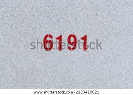 Red Number 6191 on the white wall. Spray paint.
