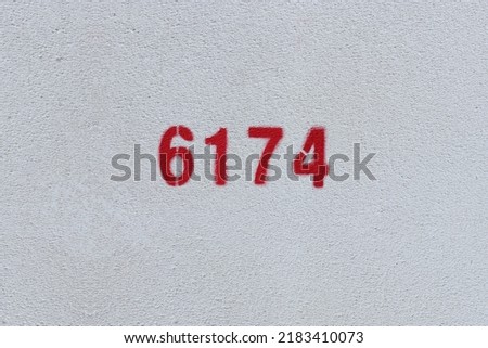 Red Number 6174 on the white wall. Spray paint.
