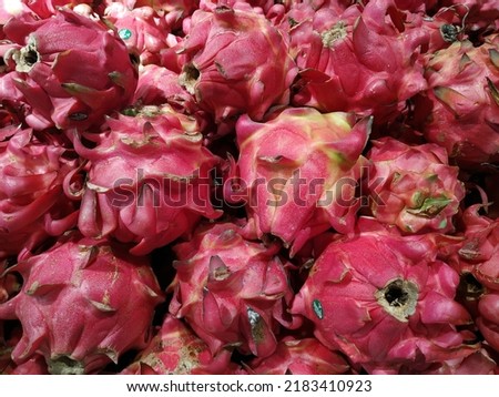 Pile of fresh super red dragon fruit in supermarket