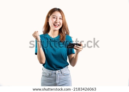 Cute Asian woman holding a cell phone and gesturing isolated on white background.