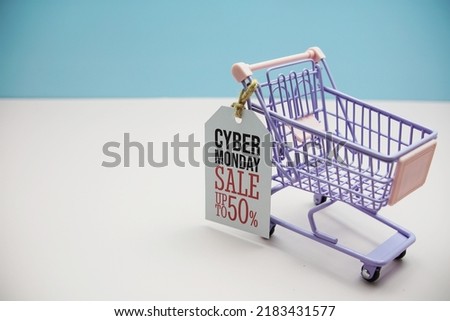 Cyber Monday SaleGreat Discount 30% offCyber Monday Sale 50%  text message on price tax with shoppint trolley cart on blue andp pink background