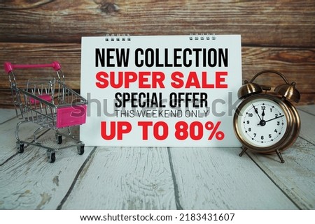 Super Sale 80%  text message with shoppint trolley cart on wooden background