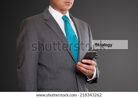 Close up of businessman text messaging on cell phone