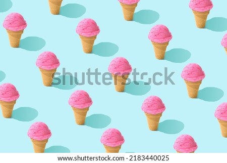 Creative art minimal aesthetic. Trendy sunlight Summer pattern made with pink strawberry ice cream on bright light blue background. Minimal summer concept.