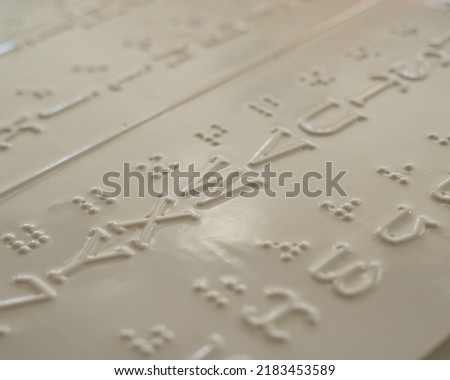 Close-up of a braille decoder with the English alphabet.