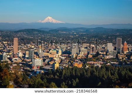 cityscape of Portland, Oregon and Mount Hood towering in distance, autumn afternoon