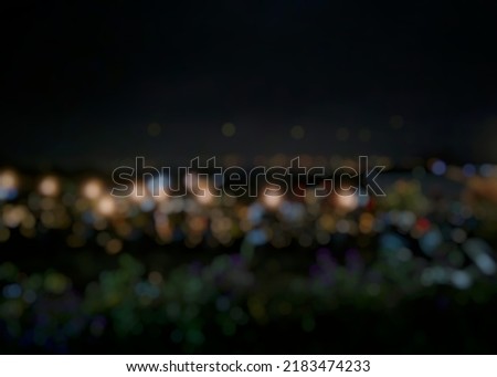 the view of the garden lights at night the photo was taken with the camera lens blur