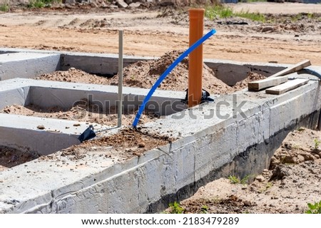 Strip foundation of a new building. The foundation for the construction of the walls of the house. Conducting communications to the building under the foundation