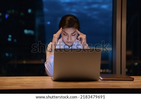 Exhausted young Indian woman worker sit stay in office late hours fall asleep at workplace working on laptop. Tired ethnic female employee distracted from computer sleep in office. Exhaustion