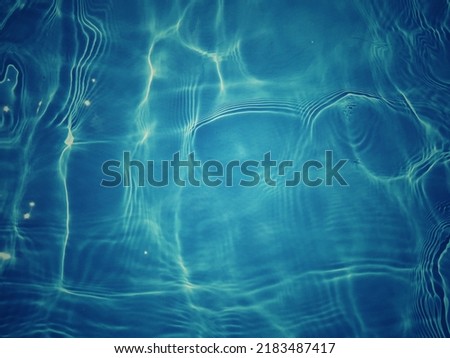 Defocus blurred blue water shining in the sea. rippled water detail background. The water surface in the sea, ocean background. Water wave under sea texture background.