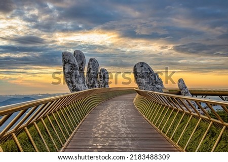 Aerial view of the Golden Bridge is lifted by two giant hands in the tourist resort on Ba Na Hill in Da Nang, Vietnam. Ba Na mountain resort is a favorite destination for tourists Royalty-Free Stock Photo #2183488309