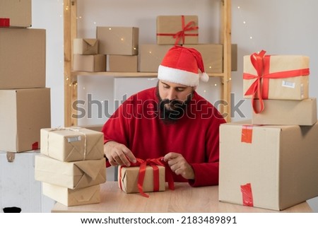 start up small business owner packing cardboard box at workplace. seller Santa Claus prepare parcel box of product for deliver to customer. Online selling, Christmas sale, commerce, shipping concept Royalty-Free Stock Photo #2183489891